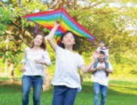 Family flying kite at the park