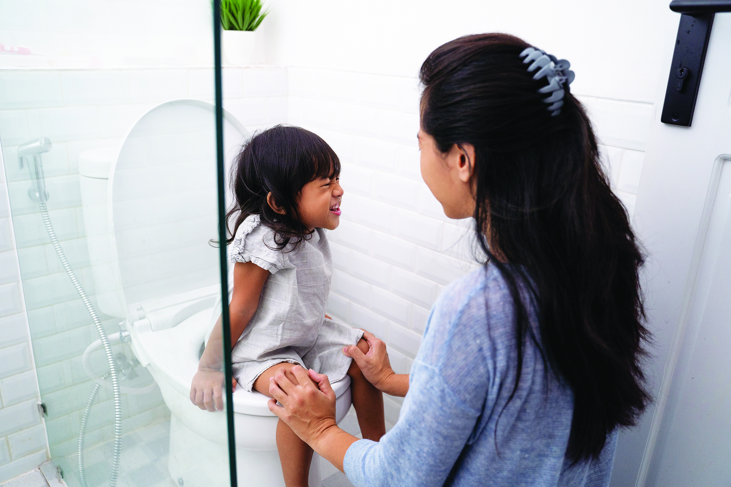 Mother Help Her Daughter To Sit On The Toilet Positive Parenting